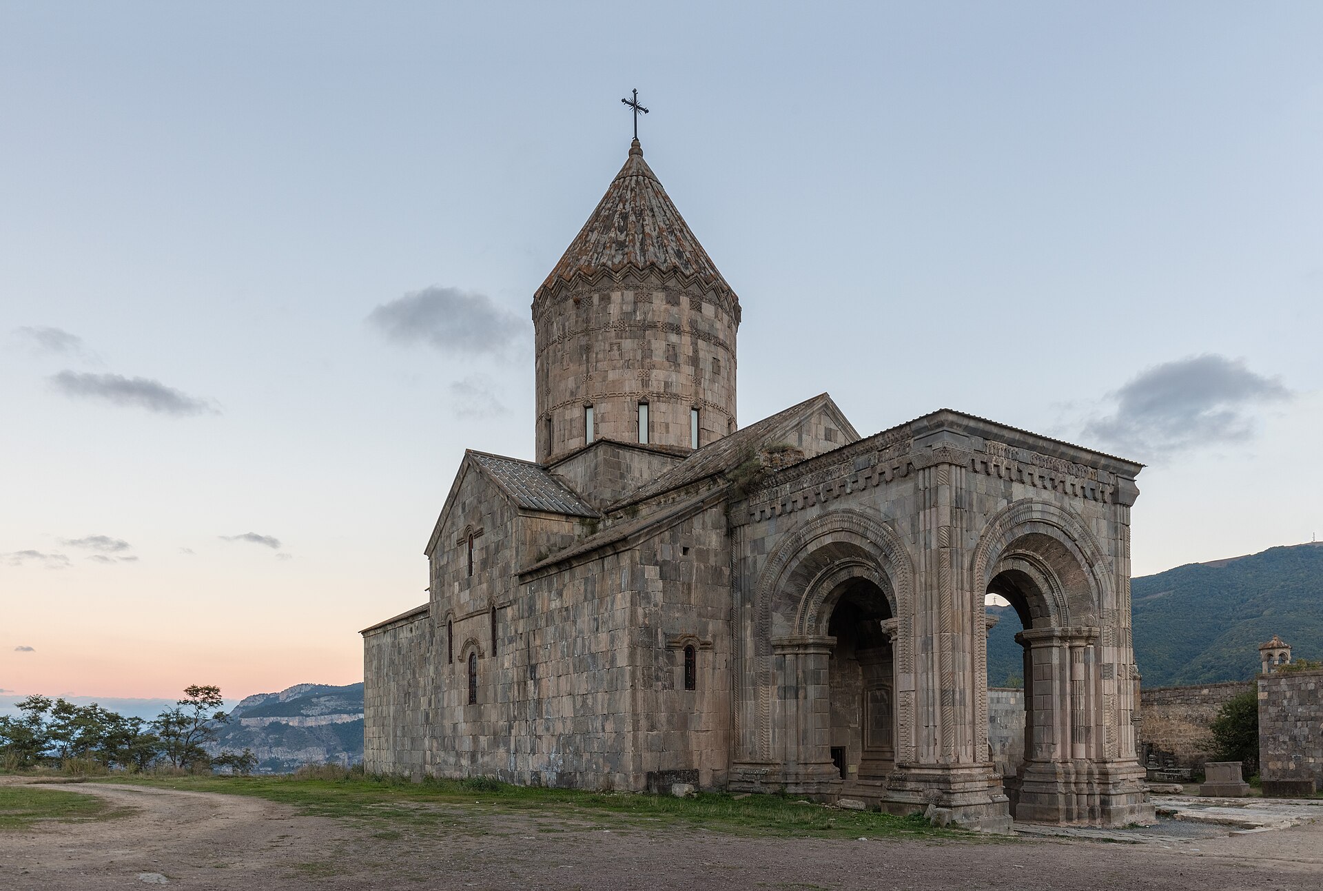 Tatev monastery at dusk, stone church and arched gallery
